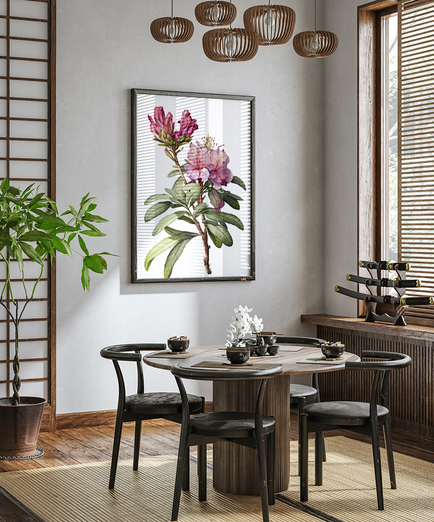 a modern dining room with a round wooden table surrounded by black chairs. A large floral painting hangs on the wall above the table, and a potted plant is placed on the left side of the room. The room has a minimalist and elegant design, with a chandelier hanging from the ceiling and a window providing natural light.