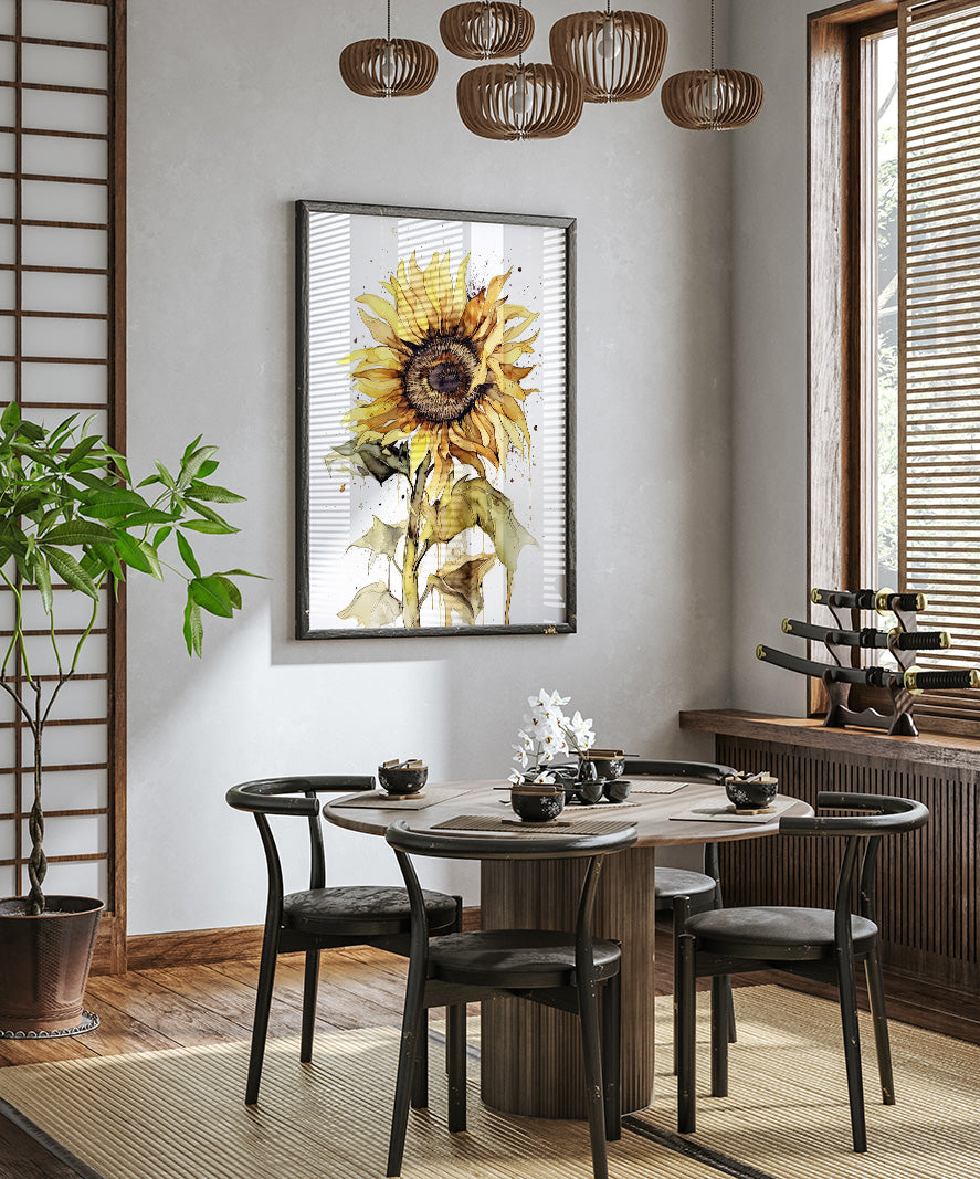 a dining room with a round wooden table surrounded by black chairs. A large sunflower painting hangs on the wall above the table, and a potted plant is placed on the left side of the room. The room has a minimalist and modern design, with a wooden floor and a window with blinds.