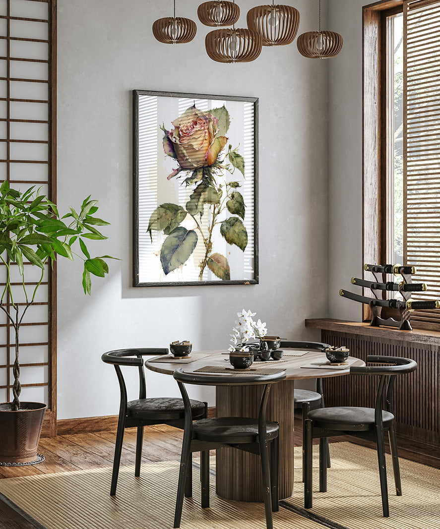a modern dining room with a round wooden table surrounded by black chairs. A large framed print of a rose hangs on the wall above the table, and a potted plant is placed on the floor next to the table. The room has a minimalist and elegant design, with a chandelier hanging from the ceiling and a window with blinds allowing natural light to enter the space.
