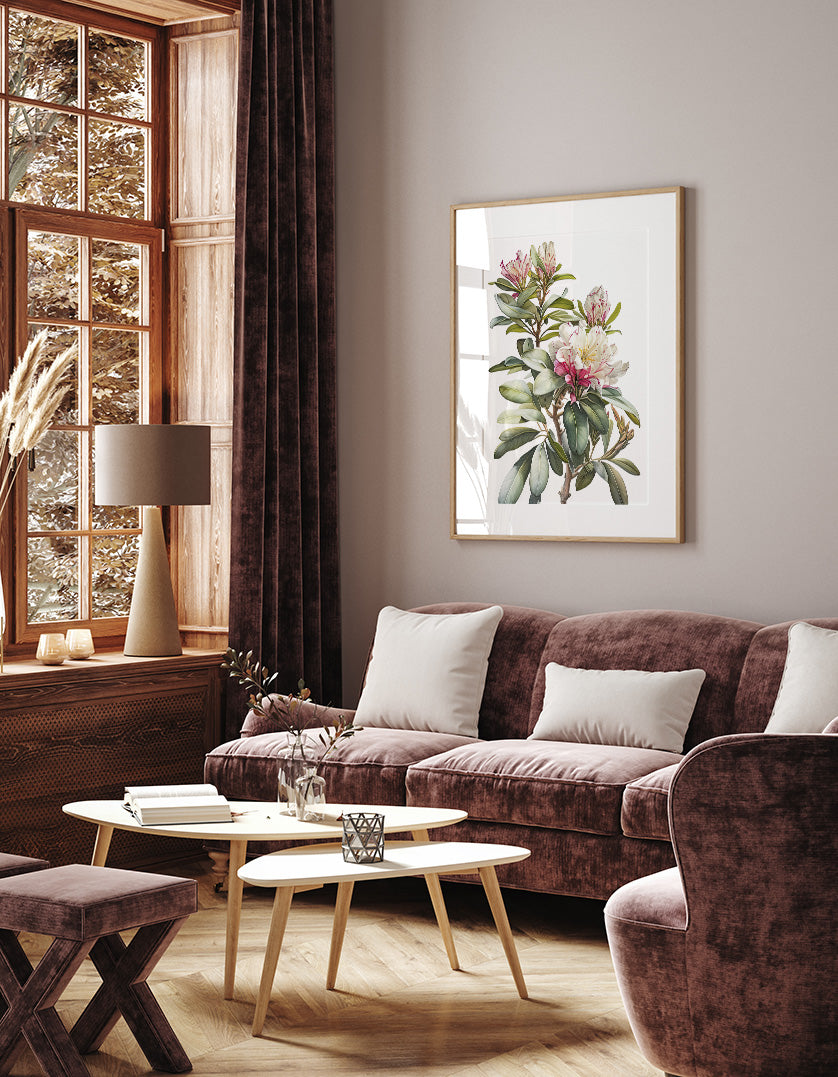 a cozy living room with a large window, a brown sofa, a wooden coffee table, and a framed painting of a floral arrangement on the wall.