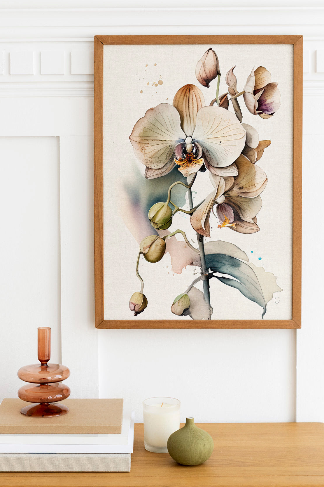 a framed painting of a flower on a wall, with a wooden shelf below it holding a stack of books, a small green vase, and a white candle.
