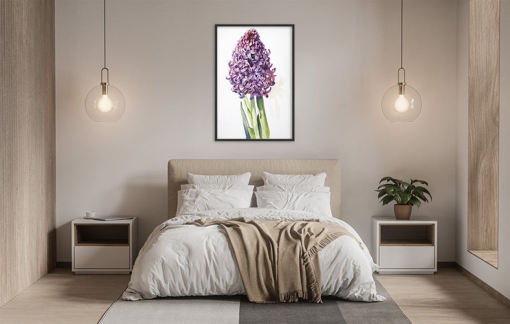 a serene and modern bedroom with a large bed, white bedding, and a framed picture of a purple hyacinth flower hanging above it. The room is illuminated by two pendant lights, creating a warm and inviting atmosphere.