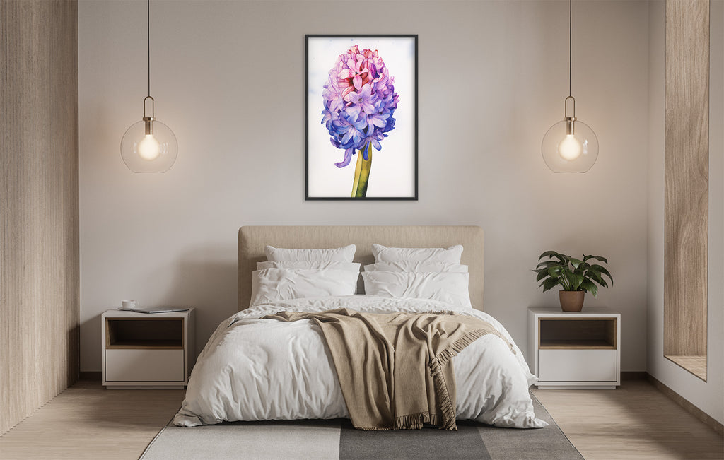 a serene and modern bedroom with a large bed, white bedding, and a framed painting of a purple flower hanging above it. The room is illuminated by two pendant lights, creating a warm and inviting atmosphere.