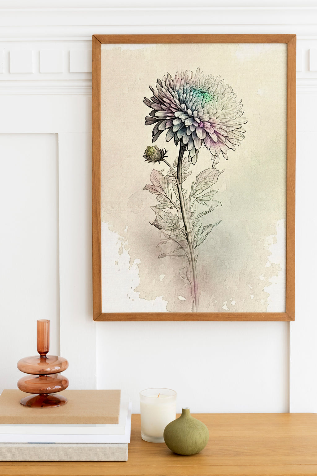 a framed watercolor painting of a flower on a wall, with a wooden shelf below it holding a stack of books, a small green vase, and a white candle.