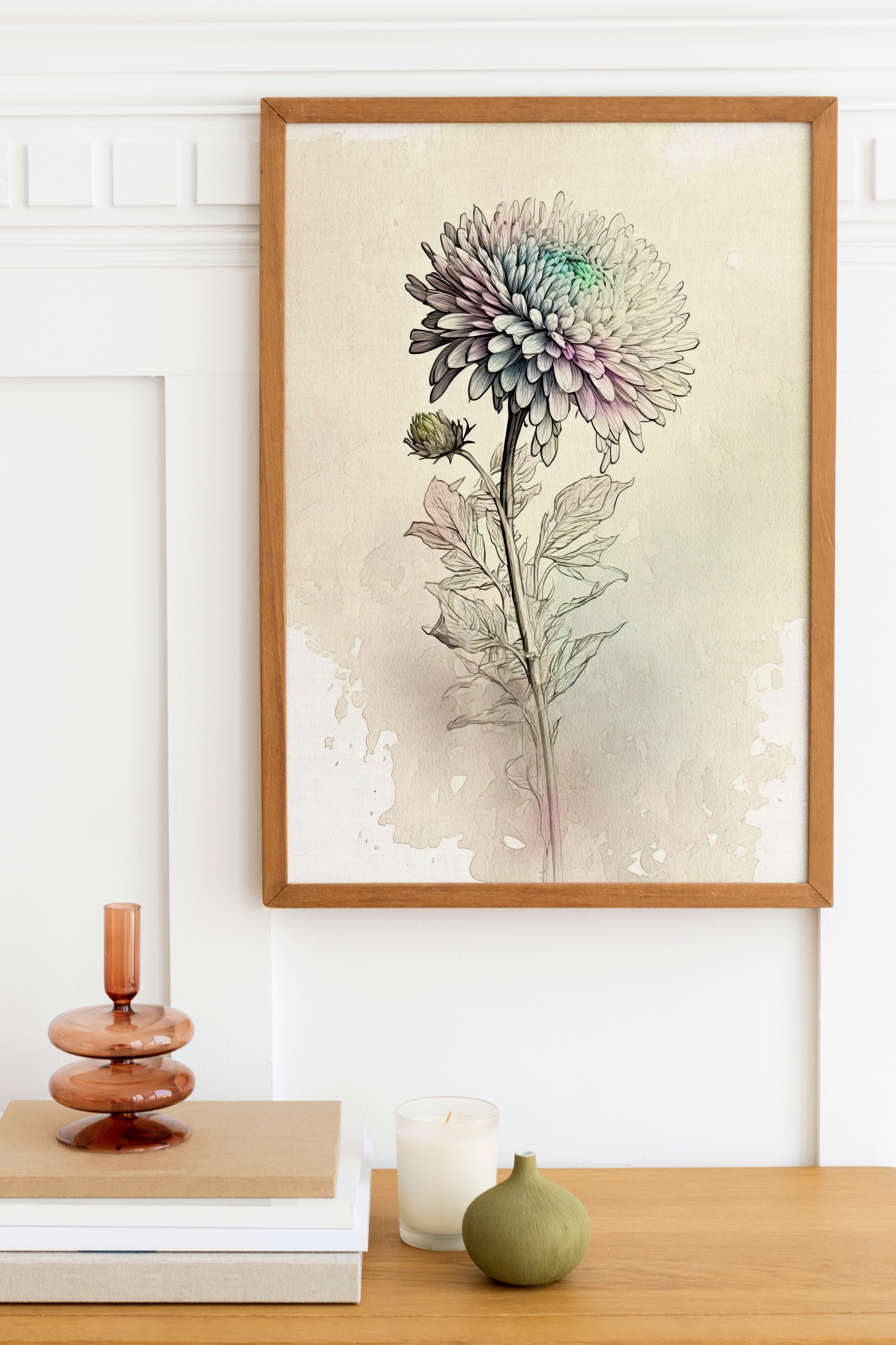 a framed watercolor painting of a flower on a wall, with a wooden shelf below it holding a stack of books, a small green vase, and a white candle.