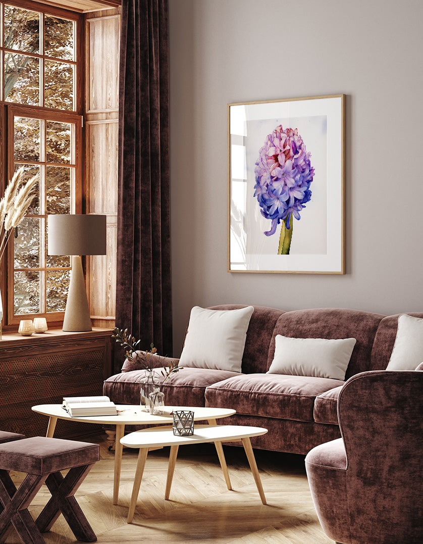 a cozy living room with a large window, a brown sofa, a wooden coffee table, and a framed picture of a purple flower on the wall.