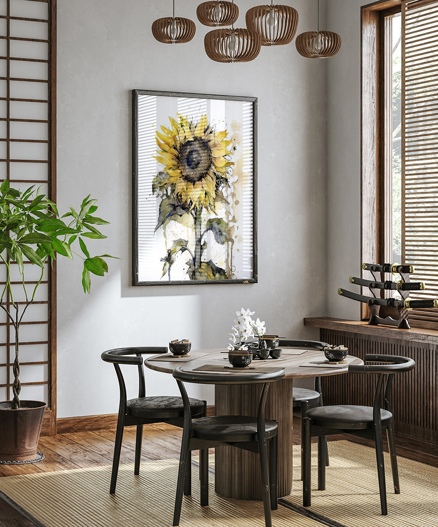 a dining room with a round wooden table surrounded by black chairs. A large sunflower painting hangs on the wall above the table, and a potted plant is placed on the left side of the room. The room has a minimalist and modern design, with a wooden floor and a window with blinds.