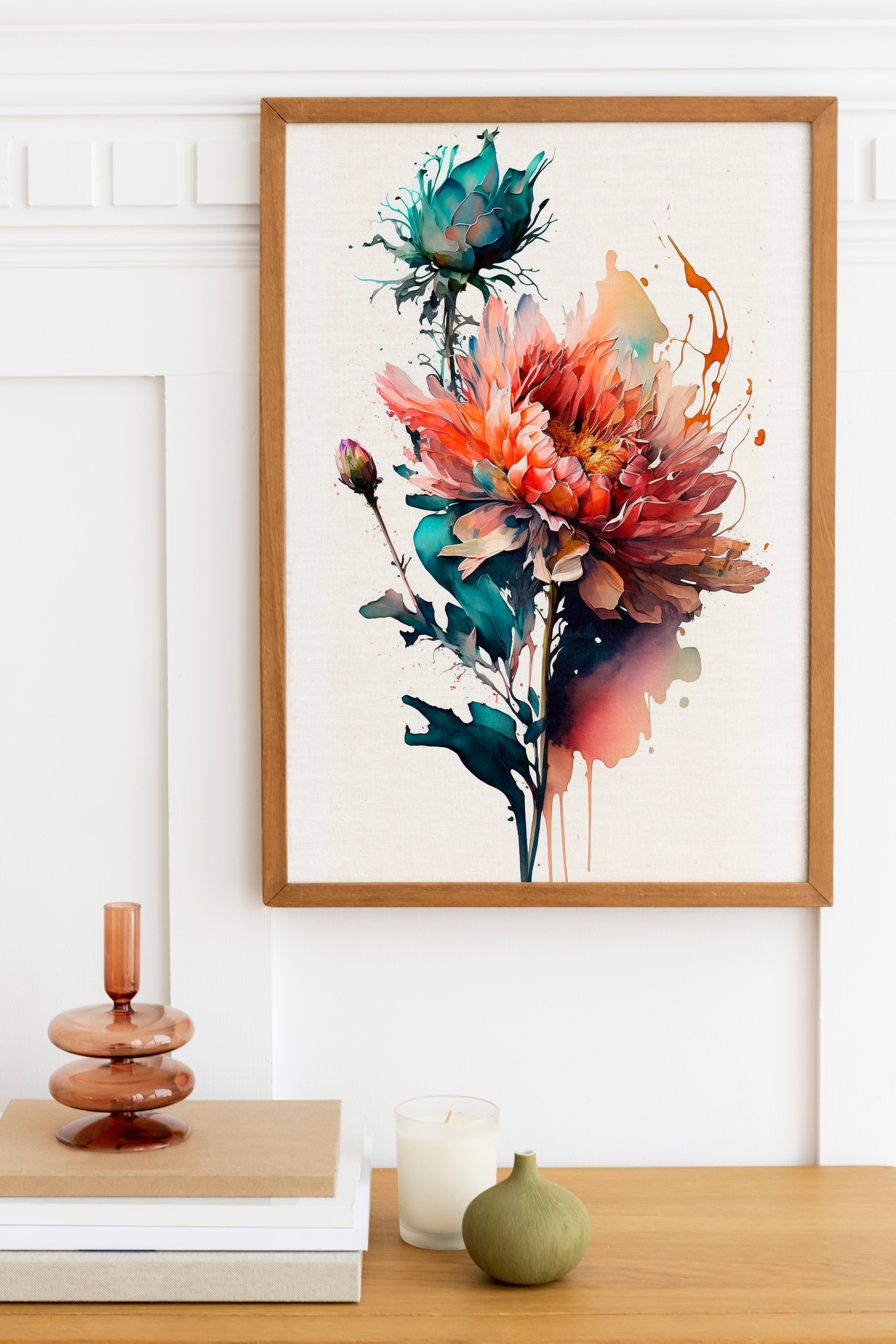 a framed painting of a vibrant, colorful flower on a white wall, with a wooden shelf below it holding a stack of books, a small green vase, and a white candle.