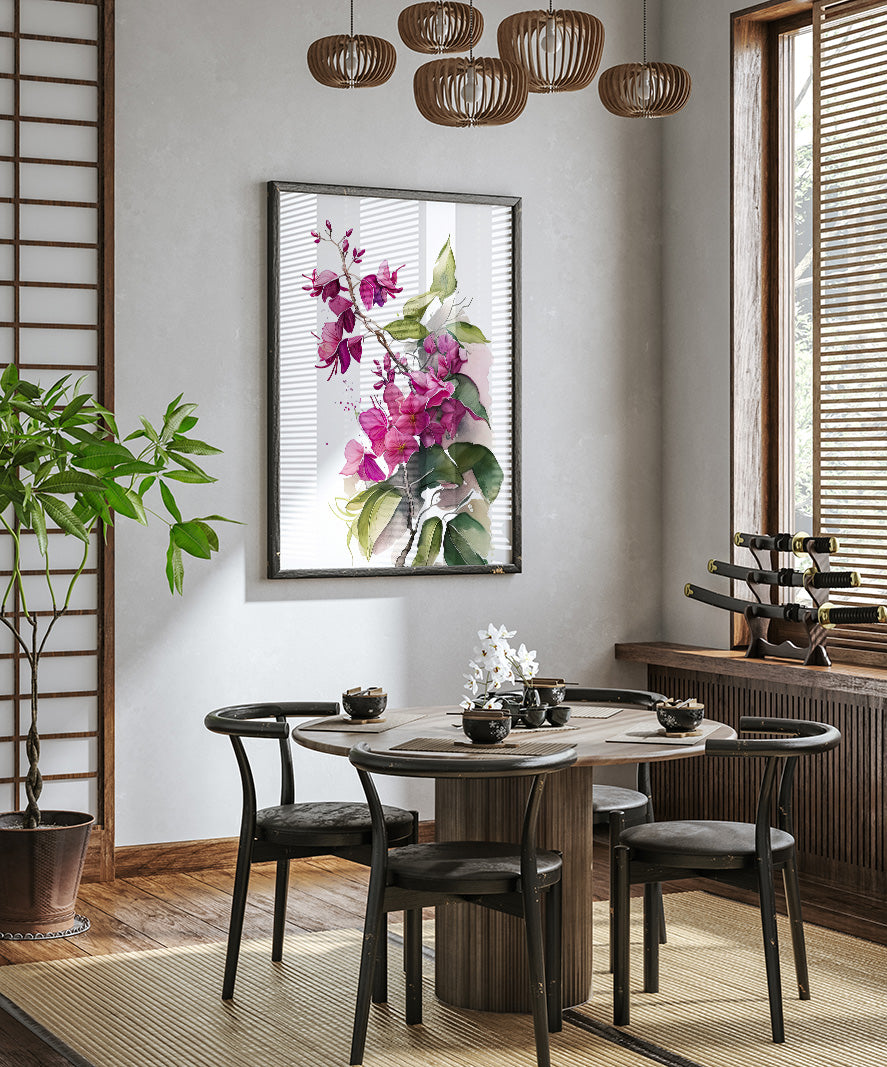 a modern dining room with a round wooden table surrounded by black chairs. A large floral painting hangs on the wall above the table, and a potted plant is placed on the left side of the room. The room has a minimalist and elegant design, with a chandelier hanging from the ceiling and a window with blinds on the right side.