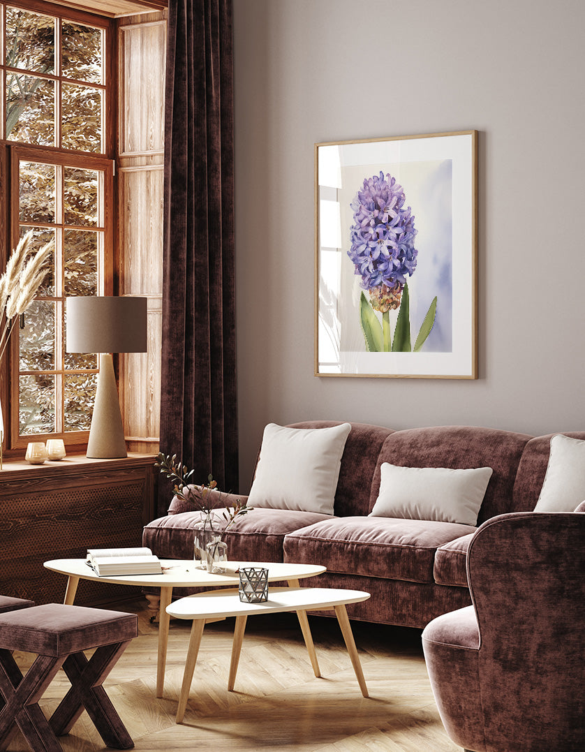 a cozy living room with a large window, a brown sofa, a wooden coffee table, and a framed picture of a purple flower on the wall.