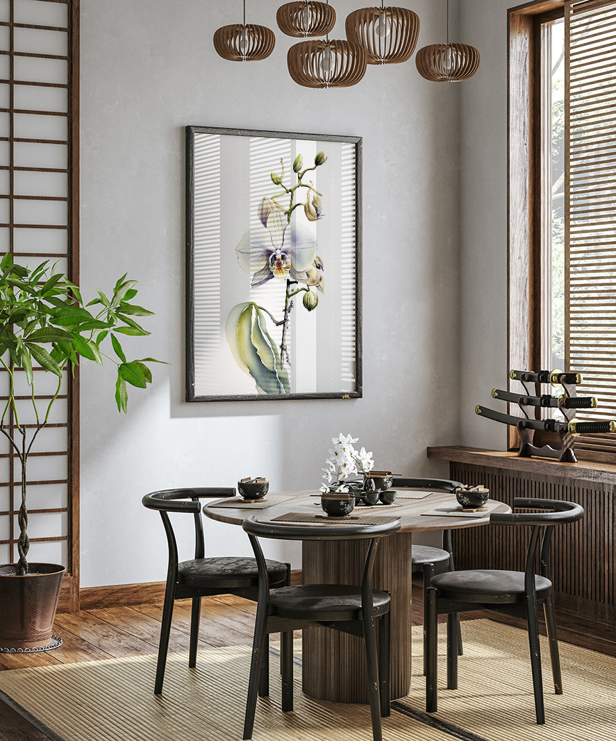 a modern dining room with a round wooden table, black chairs, and a large potted plant. A framed orchid plant is hanging on the wall above the table, and a chandelier is hanging from the ceiling. The room has a minimalist and elegant design, with a wooden floor and a large window providing natural light.